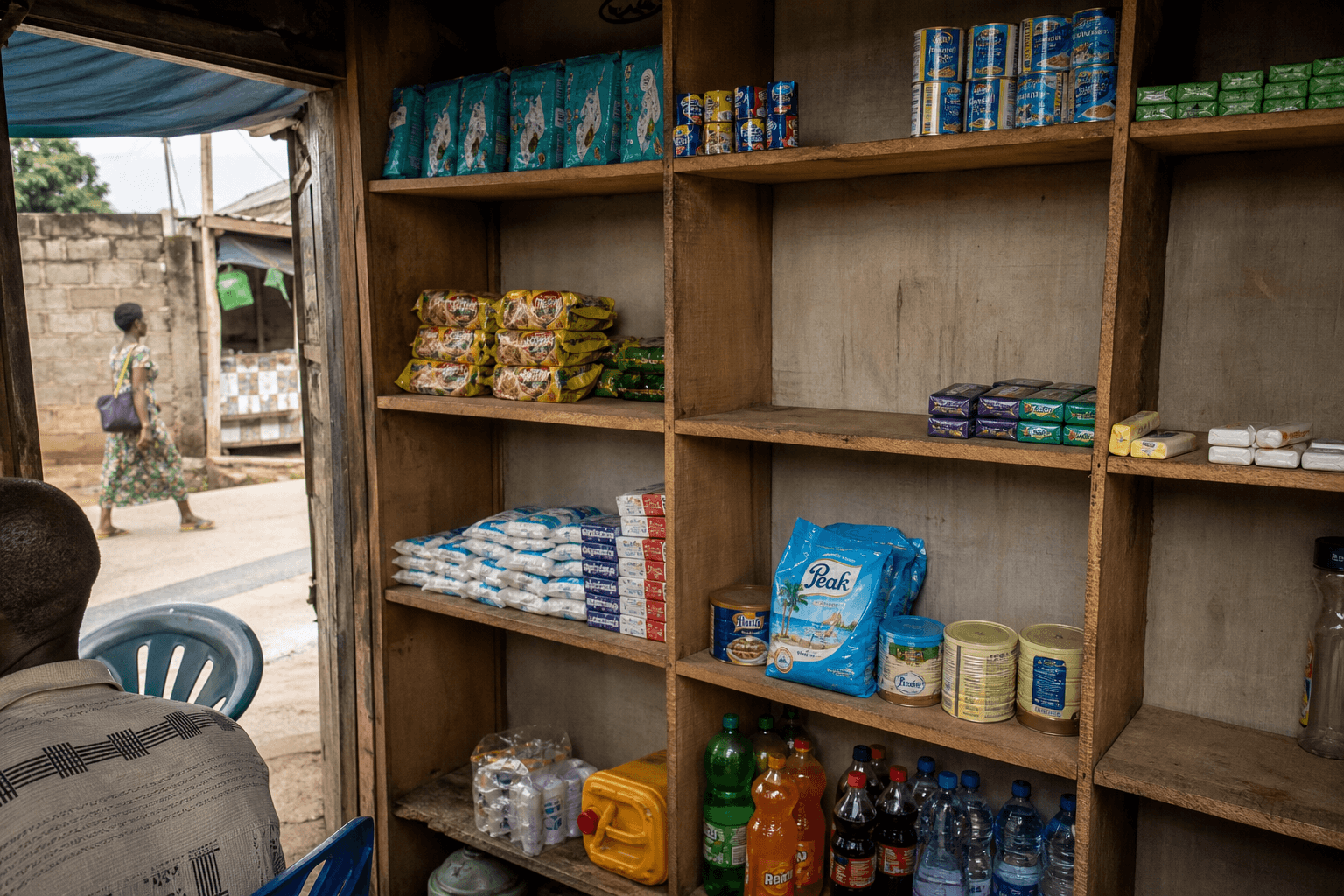 Lagos neighbourhood retail shelves with visible stock-out gaps between FMCG products